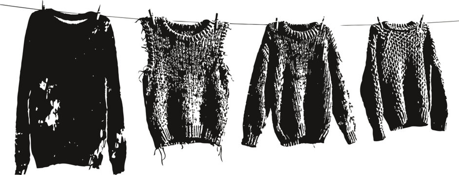 Set of four knitted sweaters and vests hanging on clothesline drying textured woolen handmade warm clothing