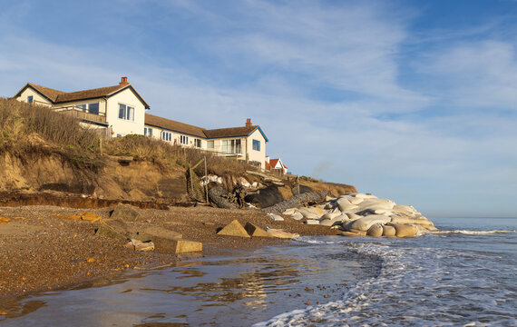 Coastal and cliff erosion on the beach causing a potential danger to properties at the top of the cliff at Thorpeness, Suffolk. UK