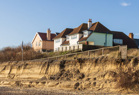 Coastal and cliff erosion on the beach causing a potential danger to properties at the top of the cliff at Thorpeness, Suffolk. UK