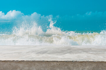 Concrete breakwater protecting the sandy beach under a cloudy summer sky captures the pristine...