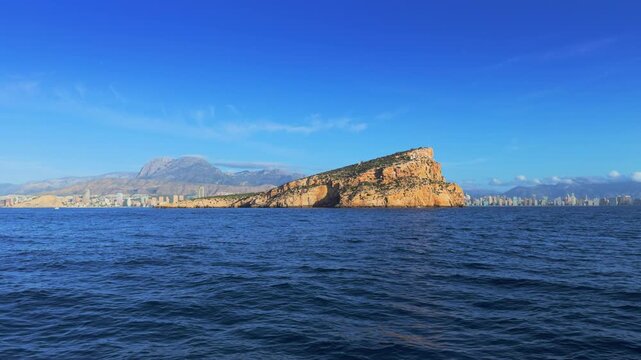 Benidorm Island and city skyline from boat Costa Blanca Spain