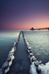 Fototapeta premium frozen coast in the morning near the sea bridge of Heringsdorf Usedom