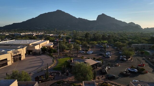 Paradise Valley, United States - 19 January 2026: Aerial view of Marriott Resort nestled against a backdrop of majestic mountains, under a clear blue sky.
