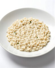 Delicate Plate of Creamy Risotto Served in an Elegant White Dish on Bright Background