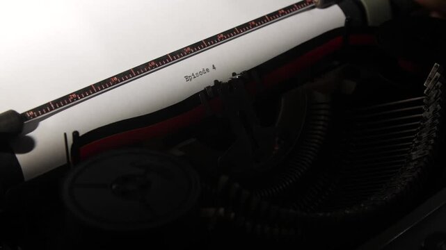 Vintage typewriter creating content, typing episode 4 onto a sheet of white paper, showing the process of storytelling, scriptwriting, and creative writing for media production