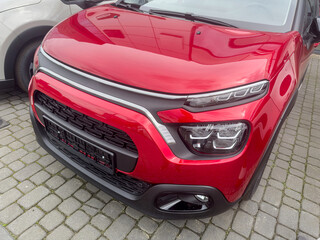 Naklejka premium red luxury new crossover car in auto salon. Expensive purchase for every one