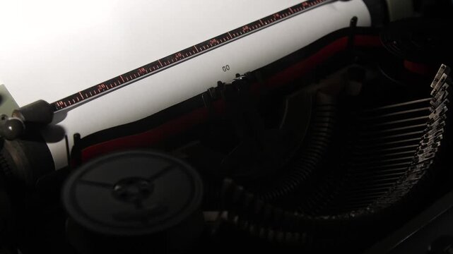 Vintage typewriter key striking paper, printing the word go on a sheet of white paper, symbolizing initiation, action, and overcoming procrastination to start new endeavors