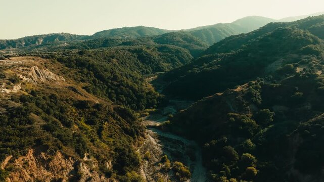 dry riverbed among the green hills