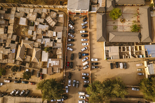 Aerial view of cars neatly parked between traditional buildings and the Emir Palace Road, Kano, Kano, Nigeria.