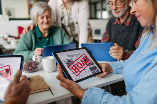 Tutor teaching seniors about scams and online risks.