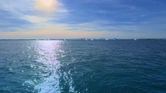 Valencia sailing regatta at sunset with small dinghies on Mediterranean