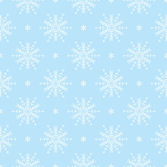 Fototapeta premium Seamless winter pattern featuring blue snowflakes on a white background. Minimalist festive design ideal for Christmas wrapping paper, holiday cards, textiles, and seasonal decorations