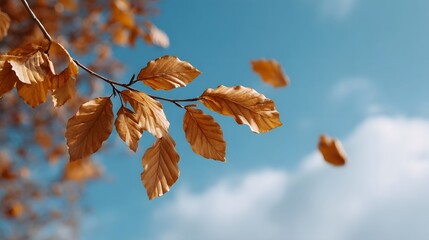 Golden autumn leaves dance in the gentle breeze against a vibrant blue sky with scattered clouds