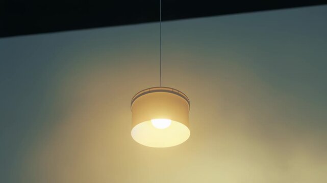 Glowing ceiling lamp provides gentle illumination, casting a warm light against a soft, ethereal background, creating a calm and contemplative atmosphere with modern design elements