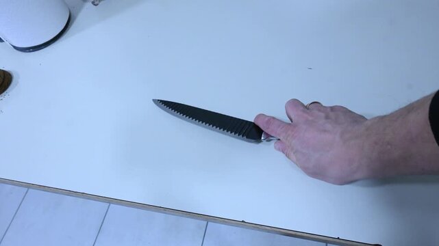 Person Picking Up a Knife by Hand &mdash; Close-Up 2