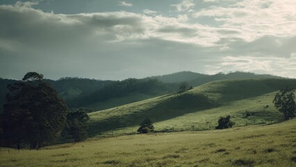 Obraz premium Green Hills Under a Cloudy Sky