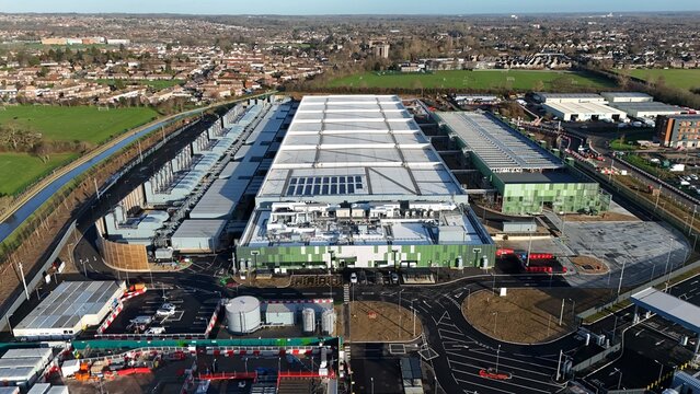 Aerial view of the Google AI data Centre with a white roof contrasting against the green facade, Waltham Cross, United Kingdom.