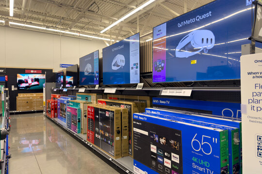 Frisco, Texas, USA - September 12th, 2025: Large wall of mounted televisions showing various content