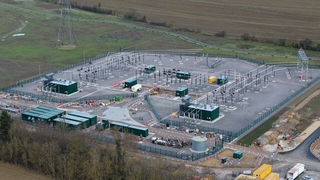 Aerial view of the substation's geometric precision against the backdrop of rural fields, Biggleswade, United Kingdom.