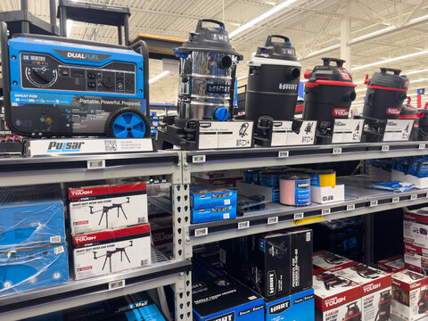 Frisco, Texas, USA - September 12th, 2025: Shelves with Pulsar dual fuel portable generator, Hart and Hyper Tough wet/dry shop vacuums, miter saw stands