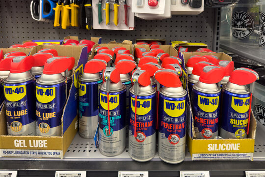 Frisco, Texas, USA - September 12th, 2025: Shelf with WD-40 specialist products including gel lube, white lithium grease, penetrant, silicone in cardboard trays