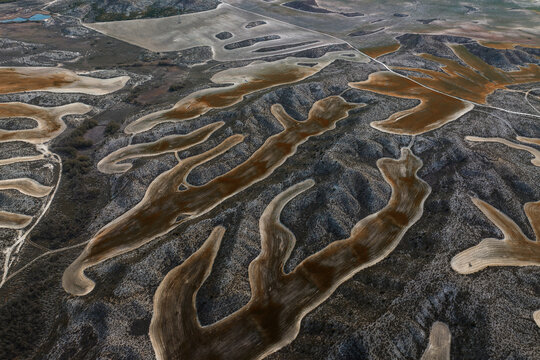 Aerial view of the stark, contrasting patterns etched into the landscape, a symphony of earthy tones and textures, Villamayor de Gallego, Zaragoza, Spain.
