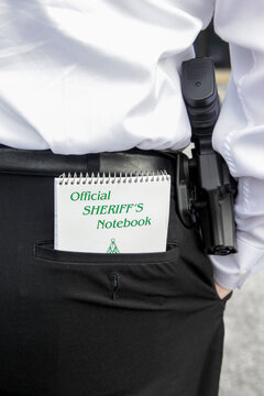 Tampa, Florida, United States. American law enforcement, officer with "Officers handbook" in his back pocket