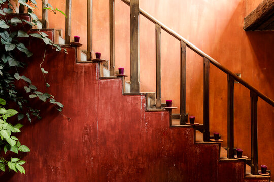 Antigua, Guatemala.  Terra cotta wall and staircase lined with candles. 