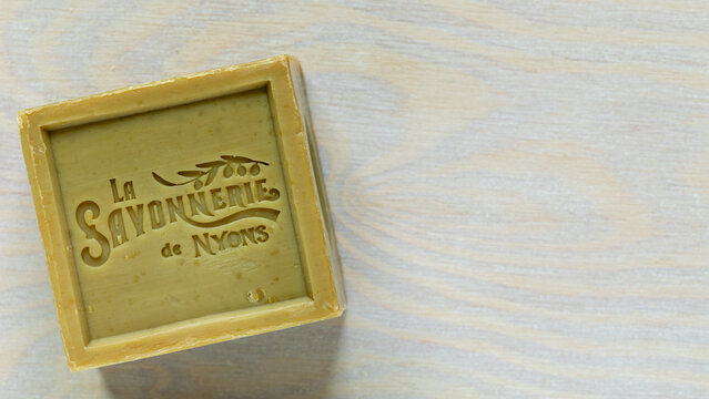 Warsaw, Poland - January 15, 2026: A bar of handmade Marseille soap containing 72% olive oil made by Soap French Factory Savonnerie de Nyons. White background with copy space.