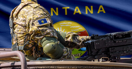 Fototapeta premium Montana US state flag with soldier at machine gun turret in front of it.