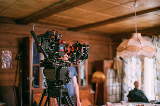 Professional cinema and video camera on the set. Shooting shift, lighting fixtures, shooting equipment and the team.