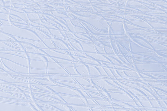 Aerial view of ski tracks etched into the pristine white snow at La Foilleuse, creating a textured, undulating landscape, Morgins, Wallis, Switzerland.