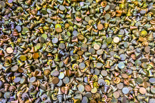 Full-frame background of iridescent Cadmium chromate plated parts closeup view