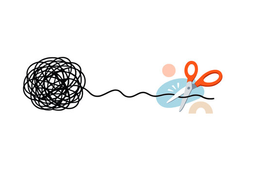 Tangled yarn sits beside scissors on a plain surface as a person prepares to cut the thread
