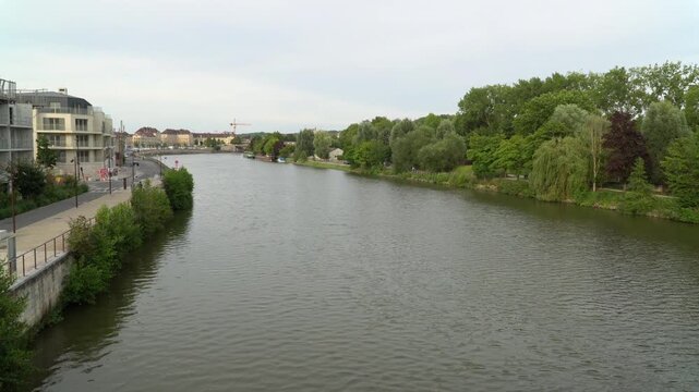 Picturesque view of lush riverbanks of Oise river in Creil, northern France.