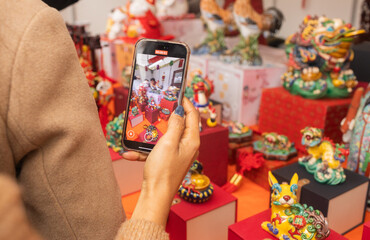 Chinese New Year market featuring traditional Asian talismans, including feng shui items, candles, dragons, lucky cats, jade ornaments, coins, souvenirs celebrating prosperity and good fortune.
