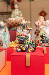 Chinese New Year market featuring traditional Asian talismans, including feng shui items, candles, dragons, lucky cats, jade ornaments, coins, souvenirs celebrating prosperity and good fortune