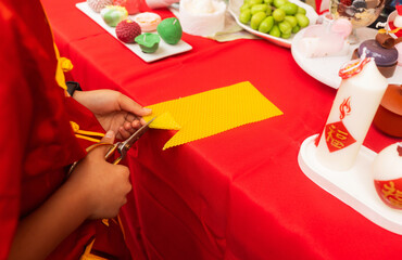 Chinese New Year candle workshop - create traditional festive symbols and Chinese characters from red paper. Cultural craft activity celebrating Lunar New Year traditions