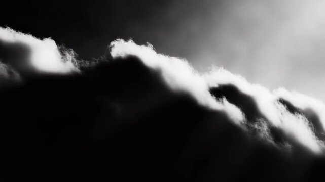 Dynamic cumulus clouds billow across a stark sky in black and white, creating a dramatic, powerful atmosphere of an approaching weather front with strong contrast and abstract beauty