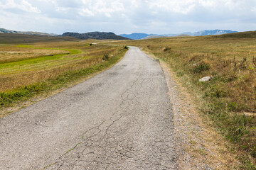 Obraz premium Landscape photography of Durmitor, Montenegro. A cracked asphalt road