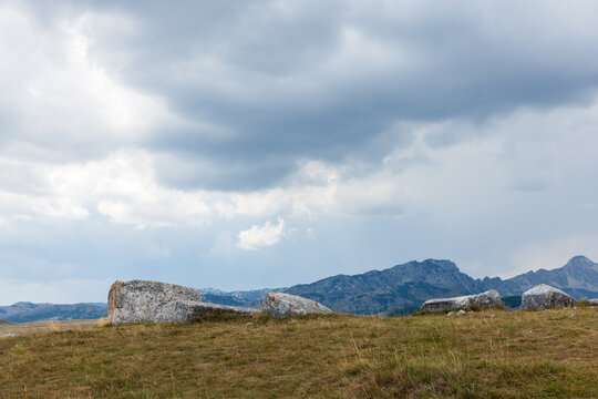 Wide hillside scene featuring ancient tombstones