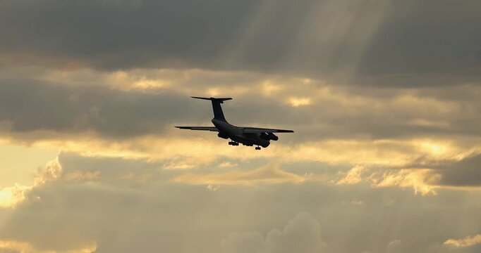 a plane in the sunset sky