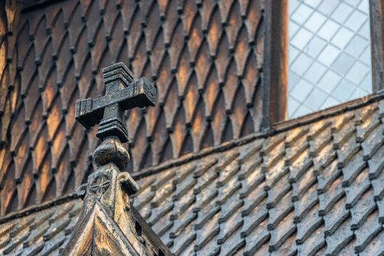 Carved wooden cross on the roof of the famous stave church in Urnes
