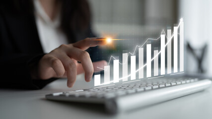 A business professional engages with digital financial data, showcasing a modern office atmosphere....