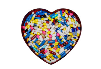 Many medical pills in the shape of a heart isolated on white background.