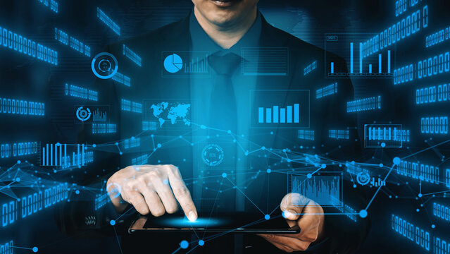 A business professional interacts with a tablet, surrounded by virtual data visualizations and charts, highlighting the significance of digital data analysis in modern business. Xenic