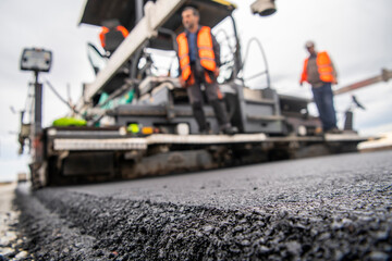 Fototapeta premium Road construction and asphalt paving and leveling machines.