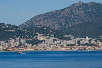 Obraz premium Sunny View of Ajaccio from Porticcio with Shuttle Boat on the Blue Mediterranean Sea