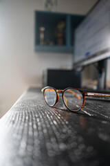 Eyeglasses on Desk in Home Office Workspace