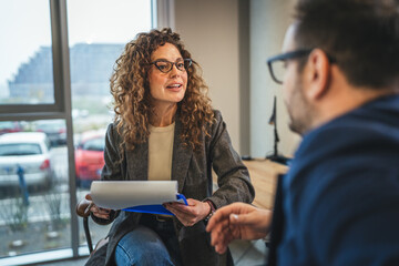 Business professionals discussing work, collaborating during a meeting